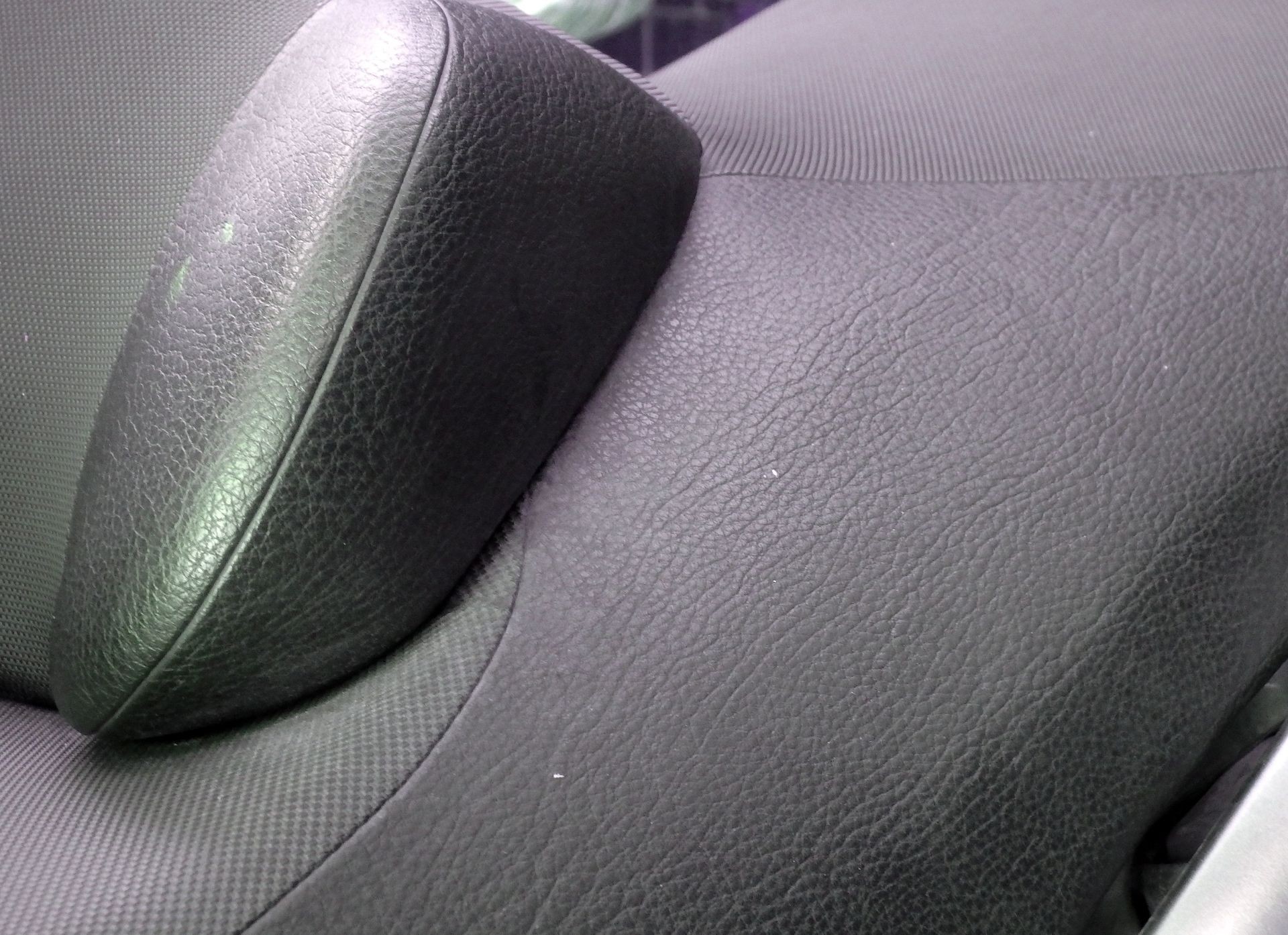 Gray background repaired car seat upholstery 
